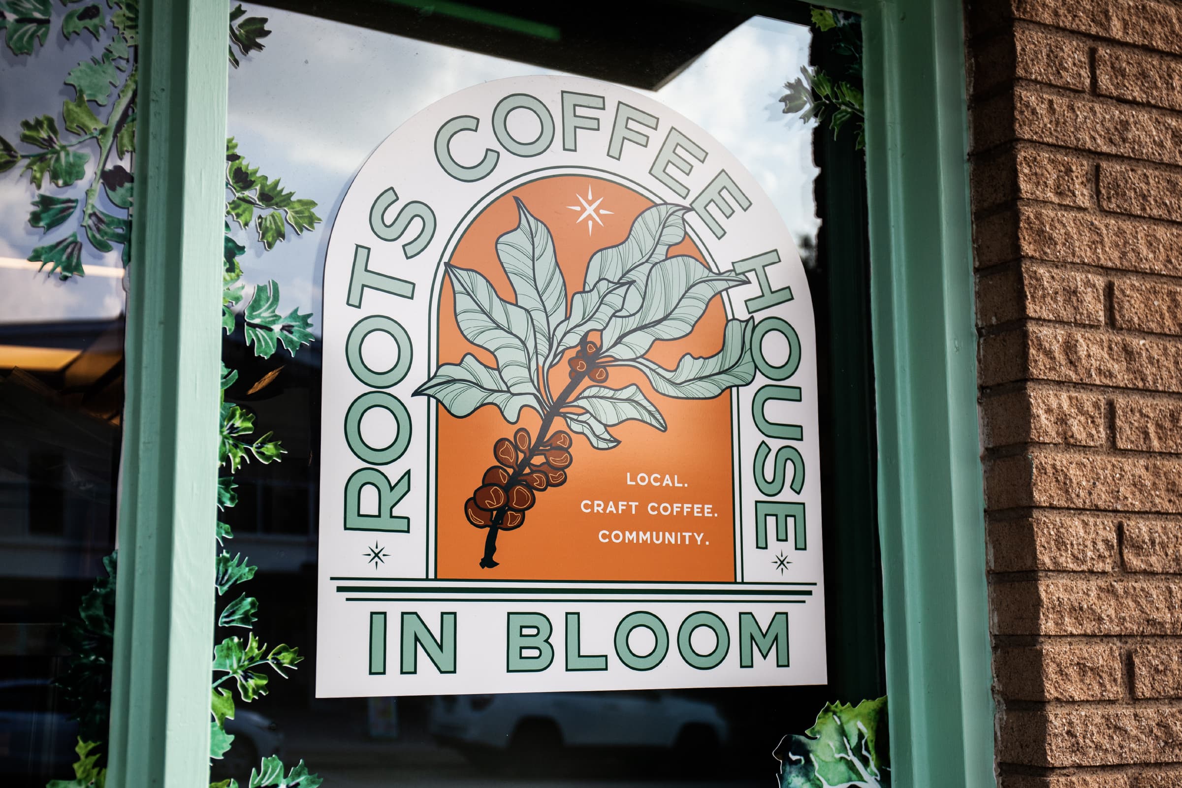 roots coffee house branding design on the boulevard of greens window