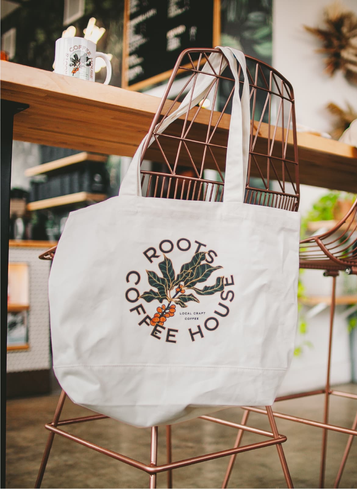 roots coffee house branding design tote bag and coffee mug on location