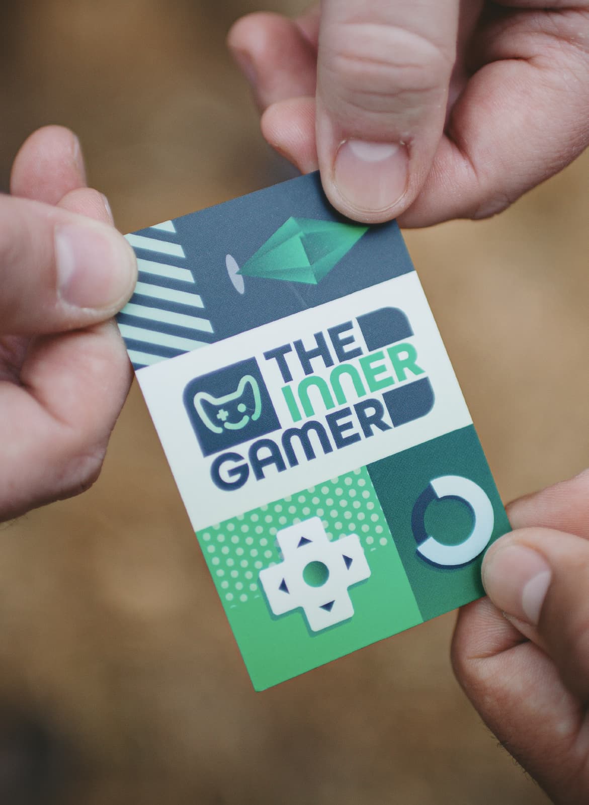 business card being held by three people, symbolic to the inner gamer