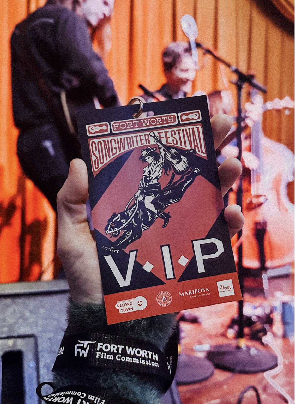 photograph of the VIP lanyard with The Simon Flory Trio playing in the background