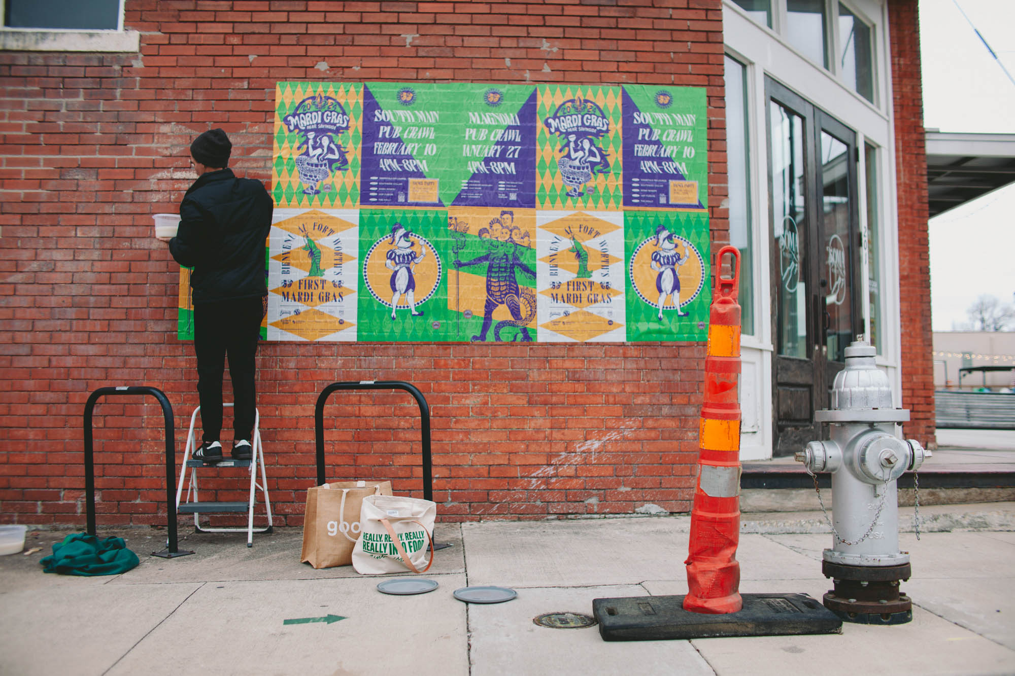 behind the scenes look at installing the mardi gras wheat pasting posters